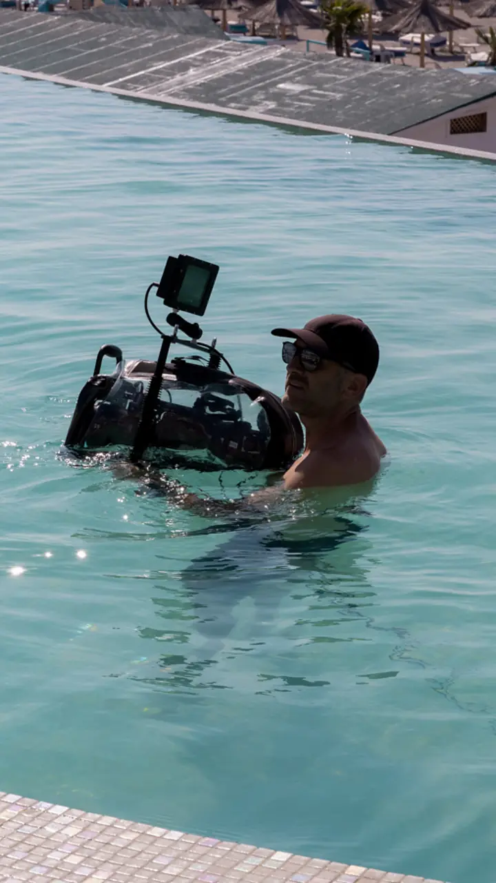 Aparatul de filmat plutind în apă, ținut de operator